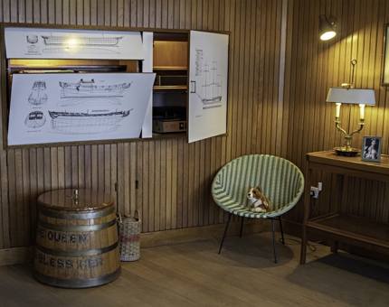 Inside the Sun Lounge, showing the 'Rum Tot' tub barrell, a chair and drinks cabinet.