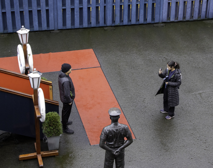 Visitors take a photograph next to the Royal Brow.