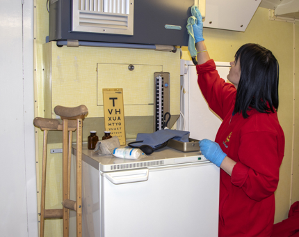 A Housekeeper deep cleaning the Sick Bay on Britannia.
