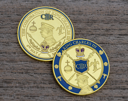 Two Coronation coins commemorating King Charles III.
