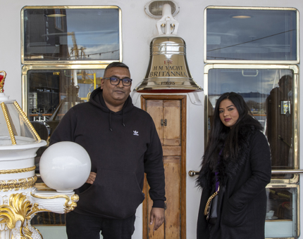 A couple standing next to Britannia's Bell.
