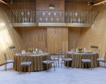 Fingal's Balllroom showing the Minstrels' Gallery and two round tables set for dining.