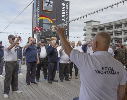 A group of Yotties raise a toast during the traditional daily rum ration.