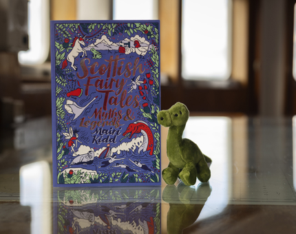 A Scottish Fairytale book and a small Loch Ness Monster plush toy 
