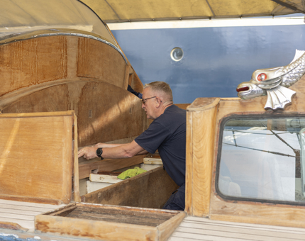 In the Royal Barge, a Maintenance team member is carrying out a refurbishment. 