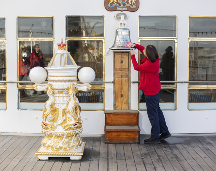 A Housekeeper is polishing the silver Bell on the Verandah Deck of The Royal Yacht Britannia in Leith. 