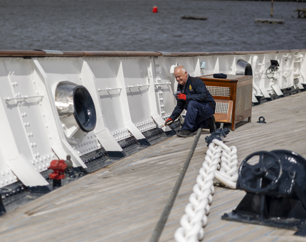 Maintenance team member, Nigel, painting the Fo'c's'le deck. 