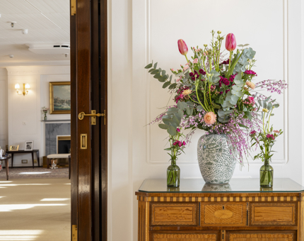Vases of flowers have been placed on a sideboard in the State Drawing Room Ante Room on Britannia. 