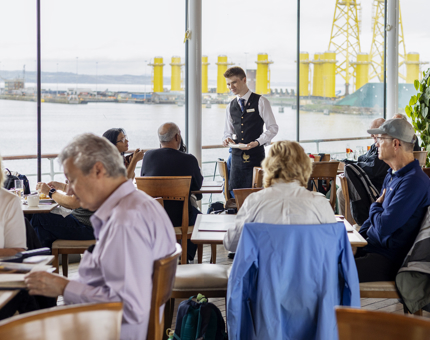 Guests in the Royal Deck Tearoom, views of the Port of leith.