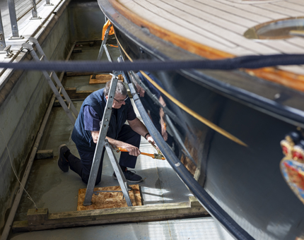 Tony from the Maintenance team working on the restoration of the Royal Barge. 