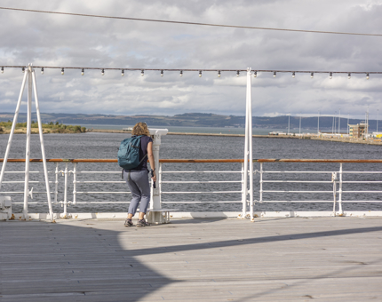 A visitor looking at the views across the Port of Leith