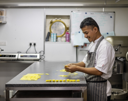 A Chef in the Galley on board The Royal Yacht Britannia making chocolate stars. 