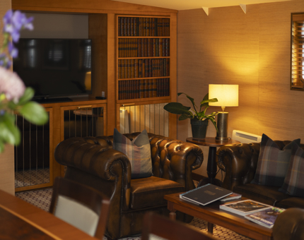 The cozy Living Room Inside The Skerryvore Suite Onboard Fingal in Leith. 