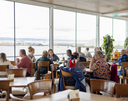 Visitors sitting at the tables in the Royal Deck Tearoom. 