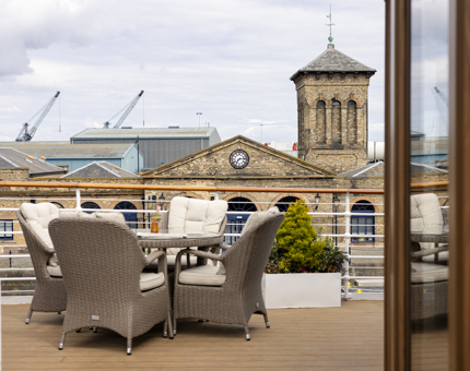 Chairs and a table outside on Fingal's deck. 