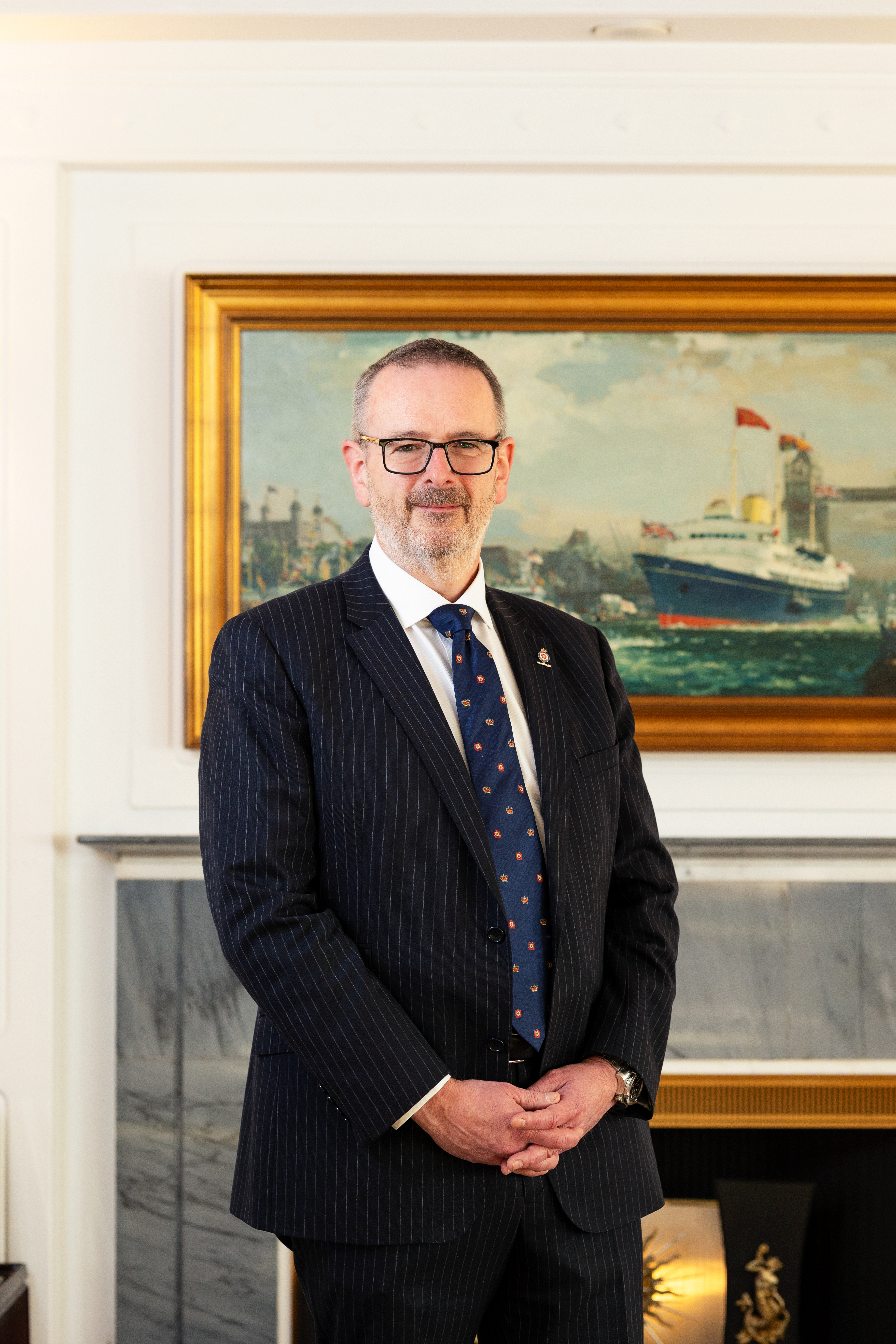 Man standing in front of painting for a portrait.