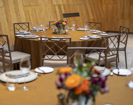 The Ballroom aboard Fingal. There are tables set with gold coloured tablecloths. 