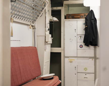 The Marines' Barracks, there is a bunk bed and lockers.