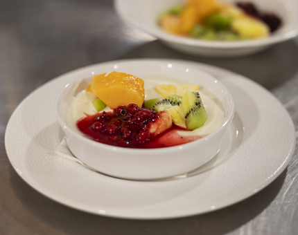 A breakfast bowl with yoghurt and fruit.