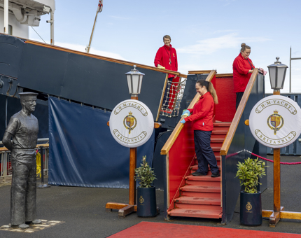 Three Housekeepers are cleaning the handrails on the Royal Brow of Britannia. 