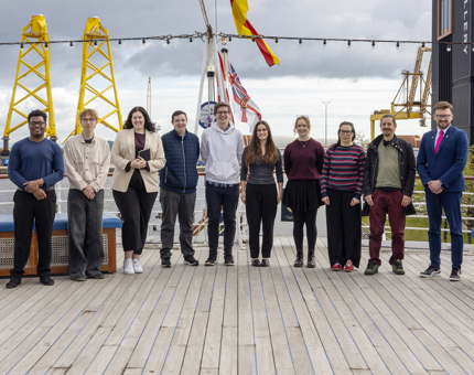 Members of staff from Britannia and Fingal pose for a photo together on Britannia's Verandah Deck in Leith. 