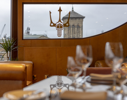 A view of the Fingal trident logo on a window of The Lighthouse Restaurant. 