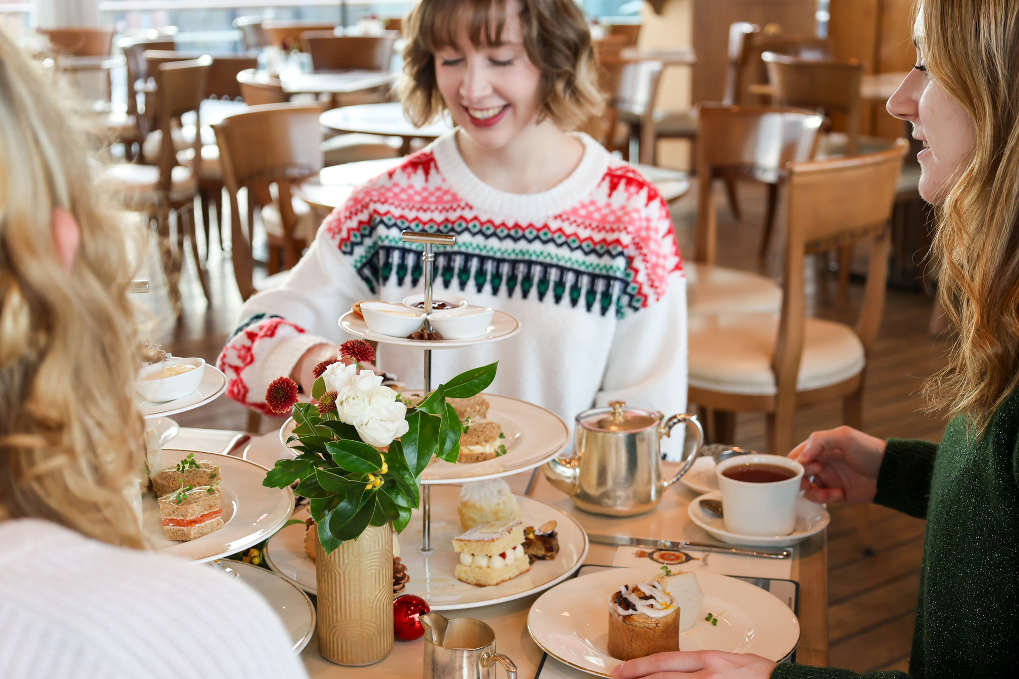 A woman enjoying afternoon tea in the Royal Deck Tearoom 