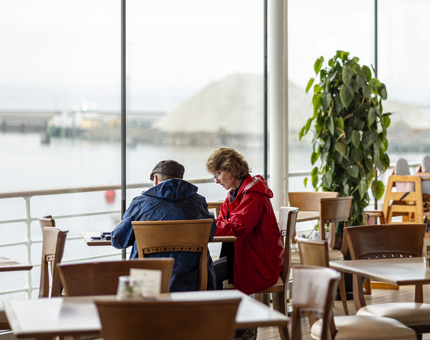 Two people sit at a table in the Tearoom.