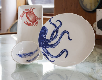 A plate, bowl and dish from the Batela Sea Style range. They have illustrations of an octopus, crab and fish on them. 