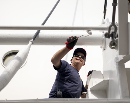 A coat of white paint is being applied to Britannia by a Maintenance team member.