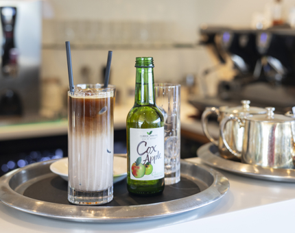 A try with a variety of drinks on it, ready to be served. 