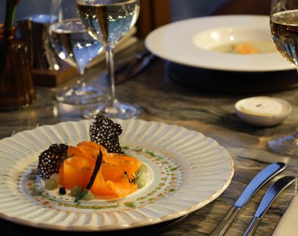 A plate with smoked salmon a set table. 