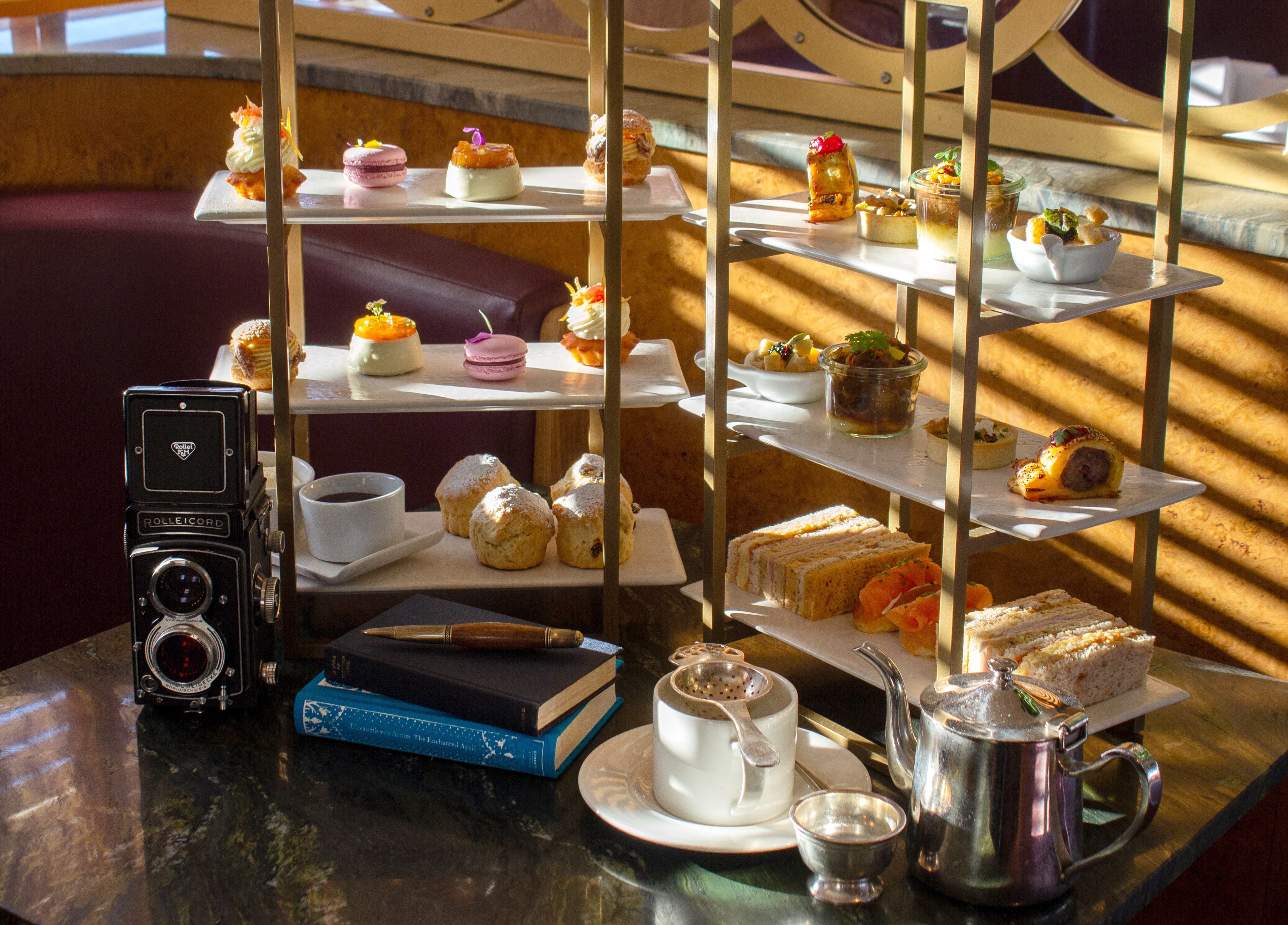 Two afternoon tea stands on tables in the Lighthouse Restaurant on Fingal
