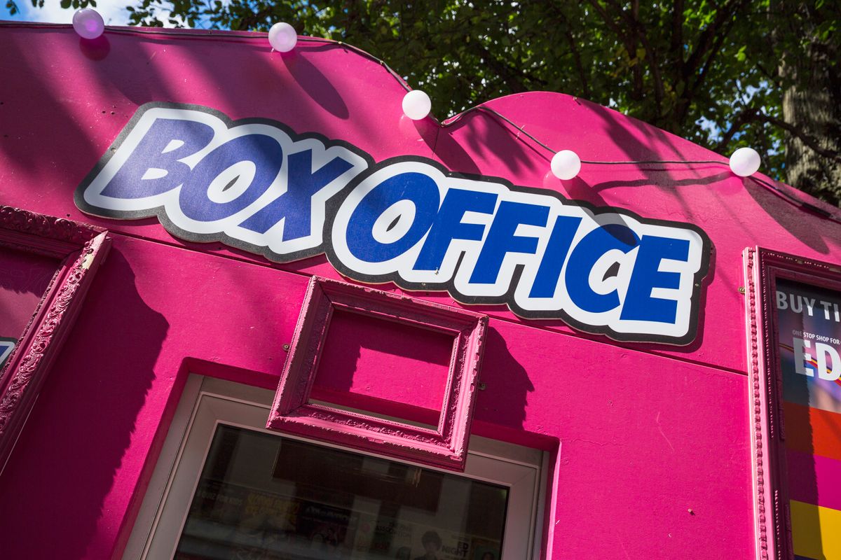 A pink and blue box office sign for the Guilded Balloon venue at the Edinburgh Festival Fringe.