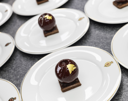 Britannia crested plates with individual Black Forest gateaux on them. 